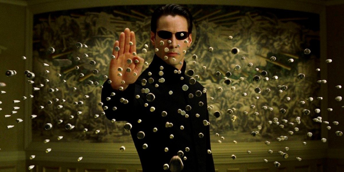 Keanu Reeves as Neo stopping bullets in The Matrix