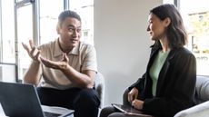 A man works with a woman on job training.