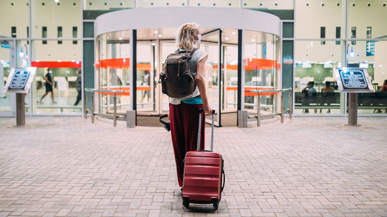 woman at departure doors of airport