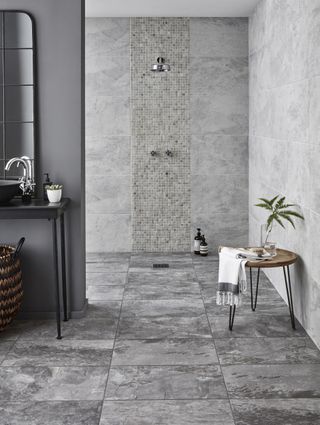 bathroom with open shower and grey tiled finish