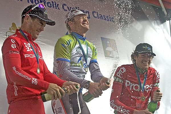 The podium spray (l-r): Rhys Pollock (2nd,Drapac Porsche), Bernard Sulzberger (1st,Fly V Australia), and Dylan Newell (3rd,Praties) on the podium in New Norfolk.