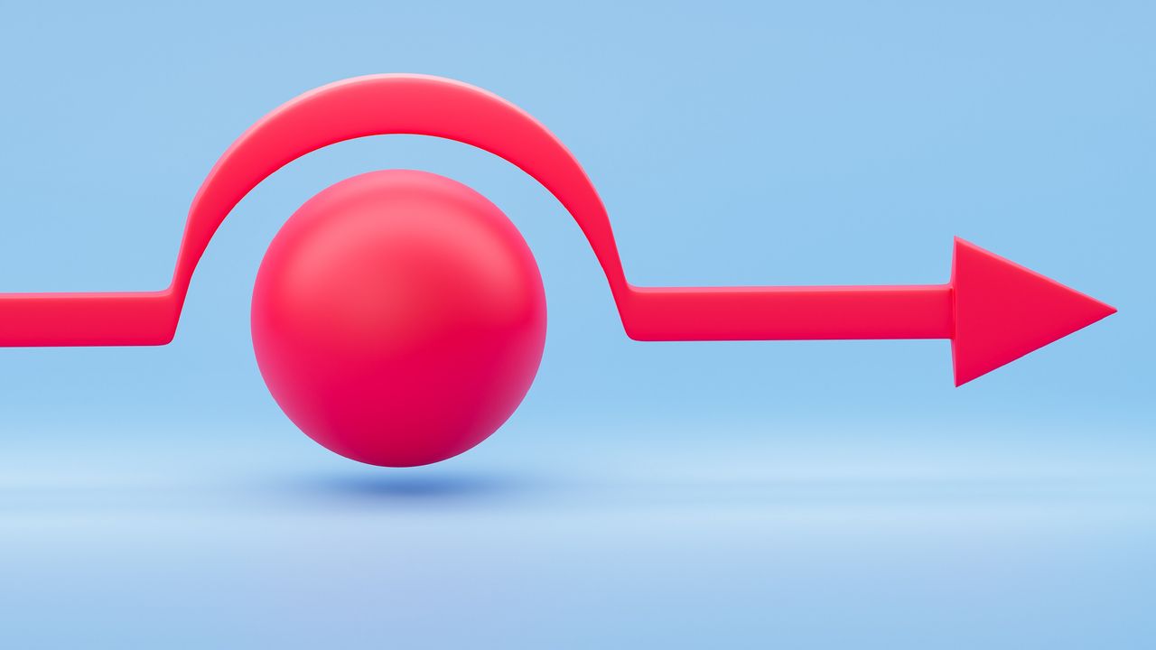 A red line with an arrow goes around a red ball against a blue background.