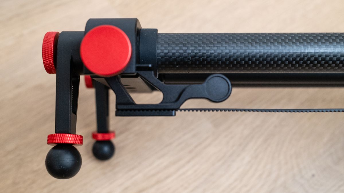 Close up of the carbon fiber material on the Neewer ER1 Motorized Carbon Fiber Camera Slider on a wooden surface