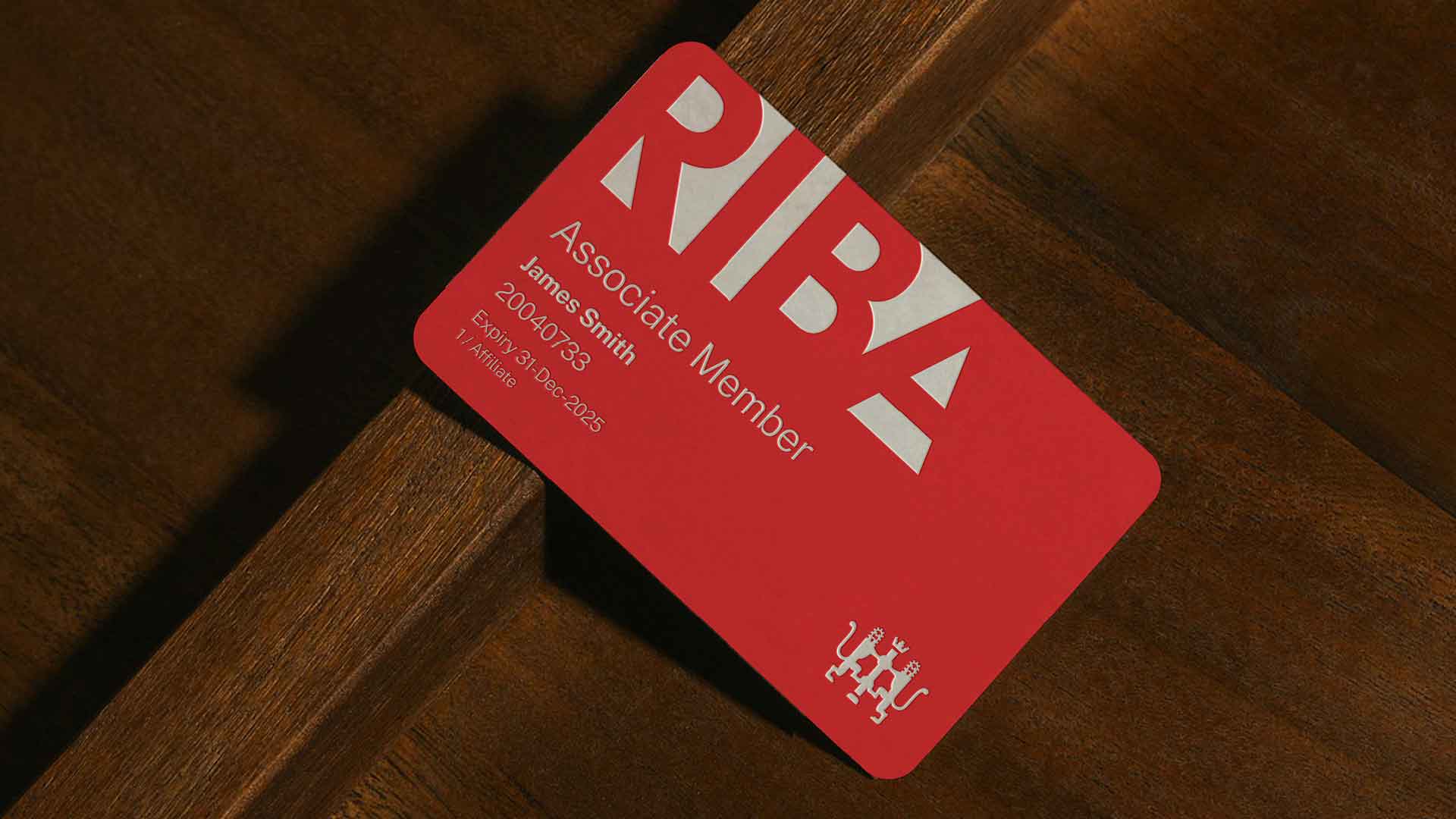 Redesign of RIBA logo with bold upper case serif font in red over white background
