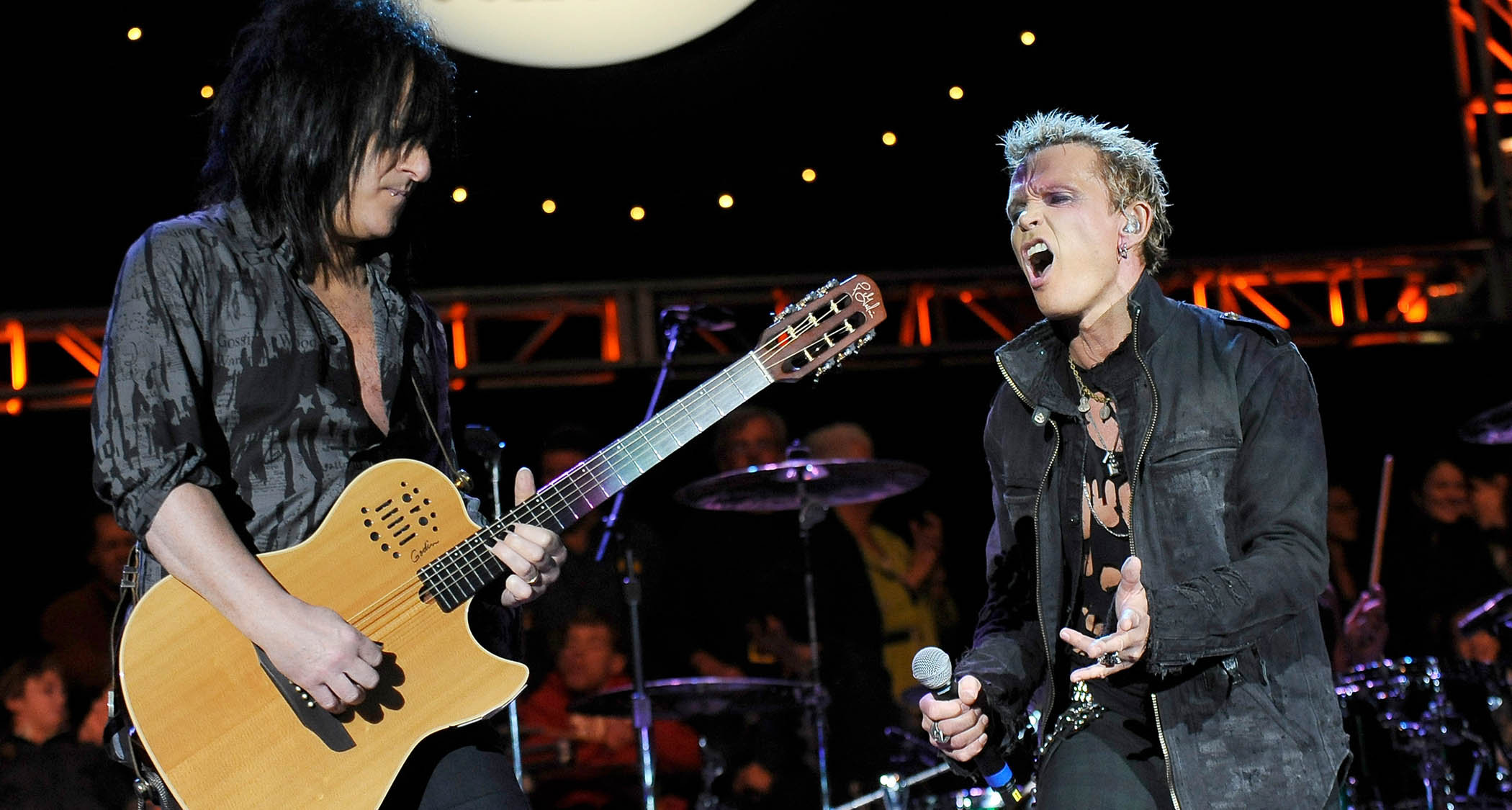 Steve Stevens takes a solo on his Godin nylon-string, much to Billy Idol's approval. Both are performing here in 2010 at Neil Young's 24th Annual Bridge Benefit 2010