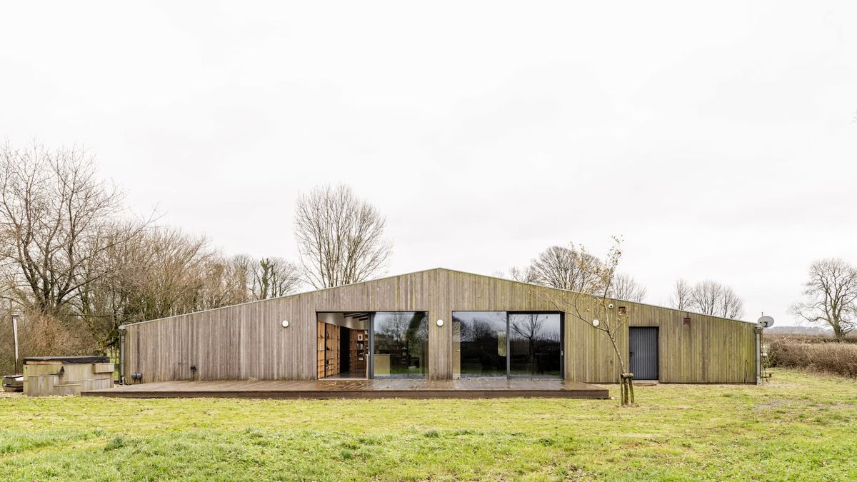 A triangular shape wooden clad single storey home