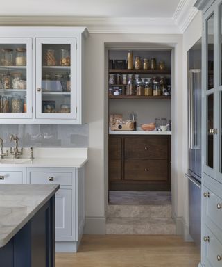 Walk-in pantry ideas with dark wooden drawers and open shelving
