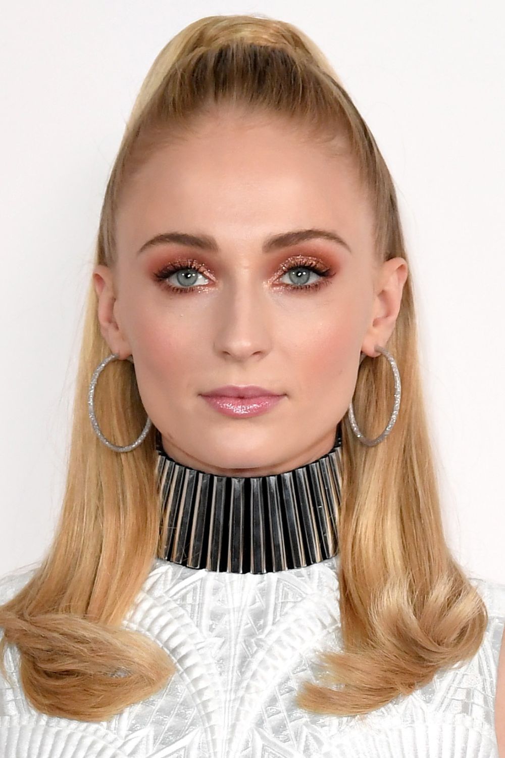 Sophie Turner wearing a half up pony