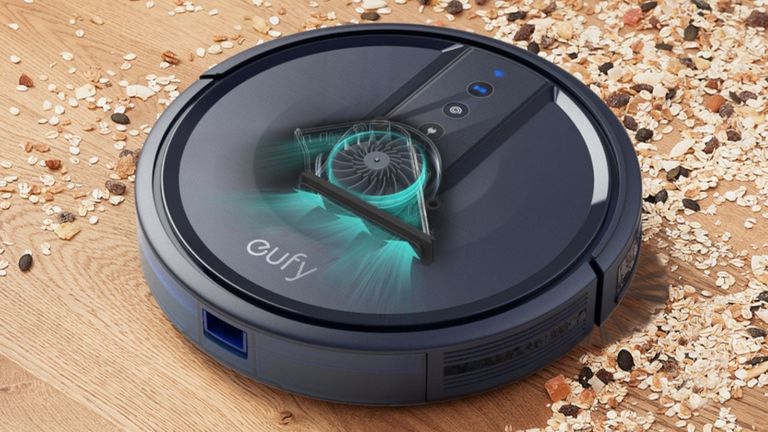 Eufy RoboVac on floor cleaning up mess