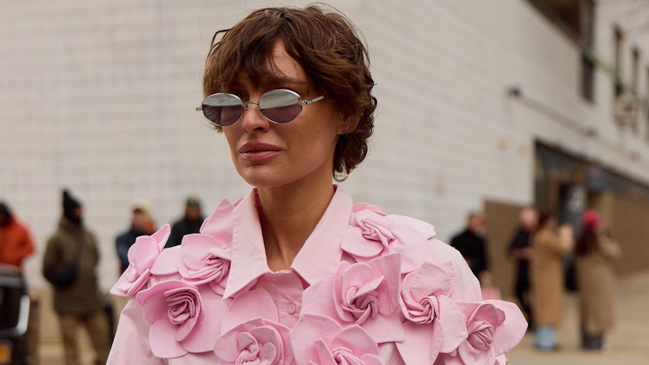 woman in a rose shirt wearing a rose fragrance