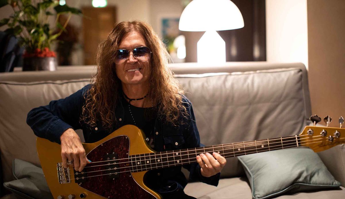 Glenn Hughes holds an Ashdown bass guitar