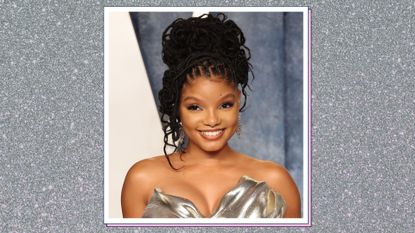 Halle Bailey pictured with her hair up and wearing a gold/silver silk dress as she attends the 2023 Vanity Fair Oscar Party Hosted By Radhika Jones at Wallis Annenberg Center for the Performing Arts on March 12, 2023 in Beverly Hills, California/ in a silver sparkly template