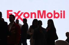 Exxon Mobil logo in red on large screen with shadowed figures at the 24th World Petroleum Congress in 2023