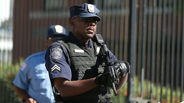 US police officer raising his gun 