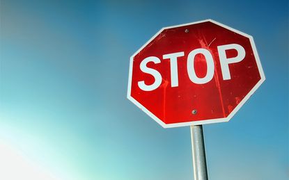 red stop sign with blue sky