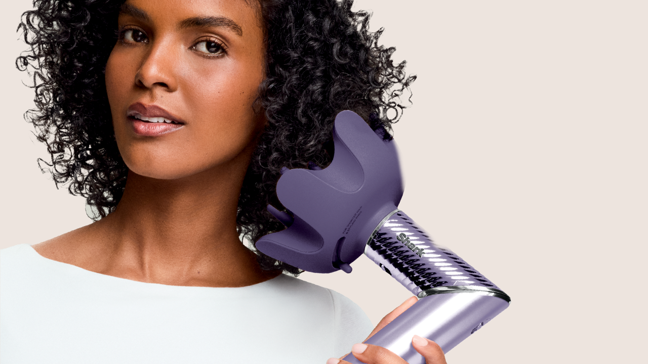 Woman styling hair using Shark FlexStyle IonCurl