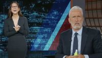 Jon Stewart and Olivia Munn on the Daily Show, June 1, 2026. Munn does a bit where she "Says goodbye to Jon on his last episode" as a tribute/joke at Stephen Colbert.