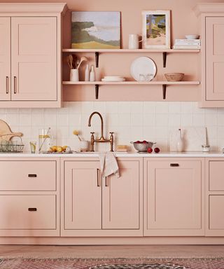 pink kitchen cabinets with white tiled backsplash