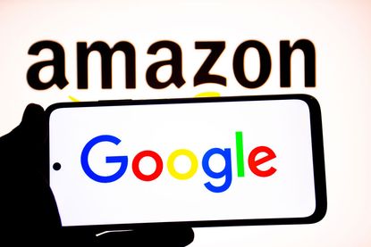 Google logo seen displayed on a smartphone with an Amazon logo in the background