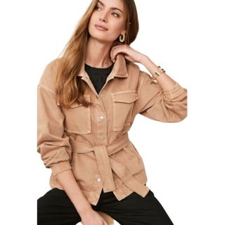 model wearing beige denim jacket