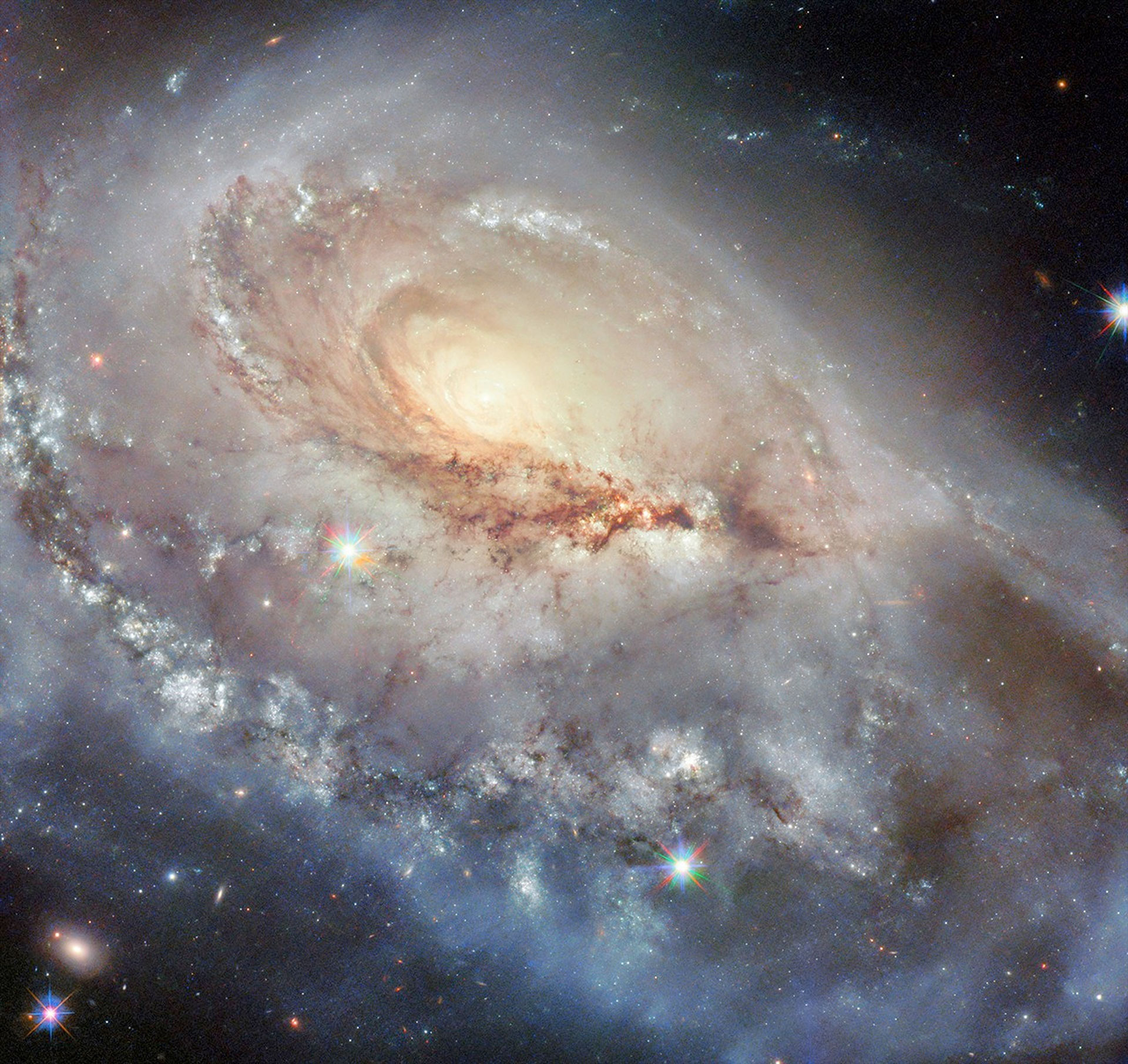 a sweeping vista of stars and dust spiraling at a skew around a bright center