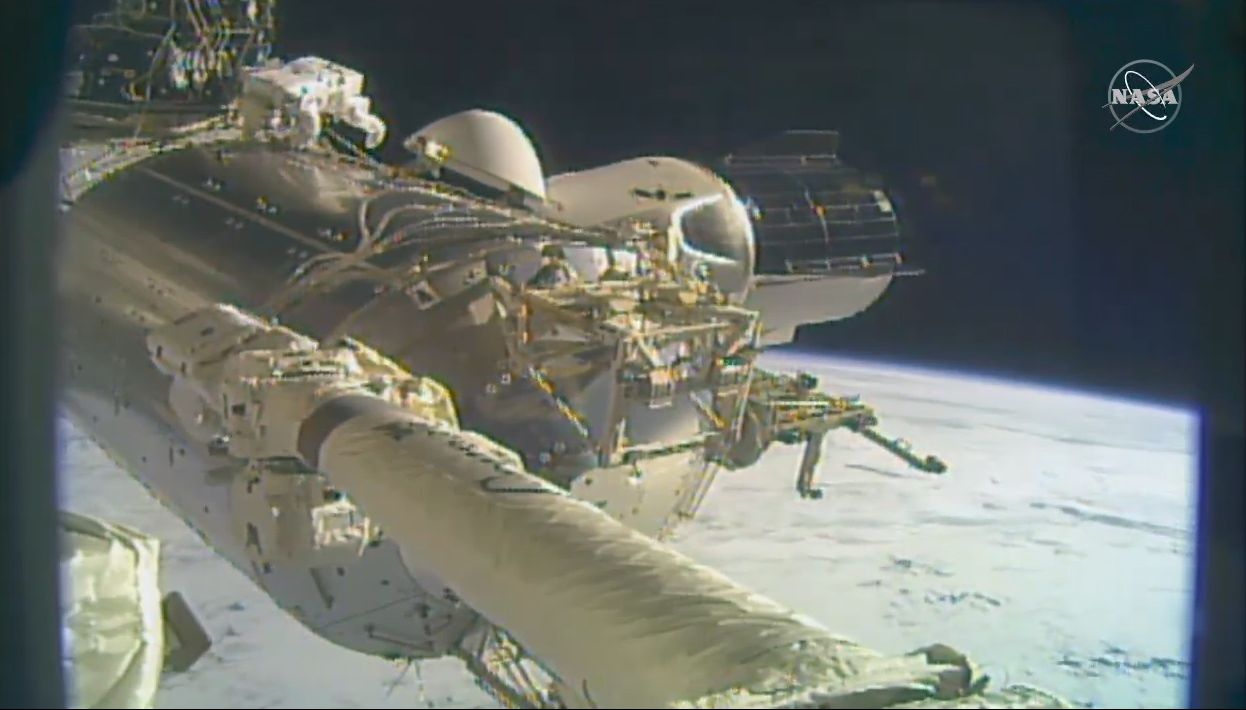 A view of SpaceX's Crew-1 Crew Dragon spacecraft (right) docked at the International Space Station. The spacecraft ferried four Expedition 64 astronauts to the station in November, including NASA's Victor Glover and Michael Hopkins, who took a spacewalk on Jan. 27, 2021.