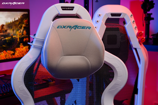 A detail shot of the DXRacer Air Series’ headrest. It is almost oval shaped, grey, and has DXRacer embroidered into the fabric at the top.