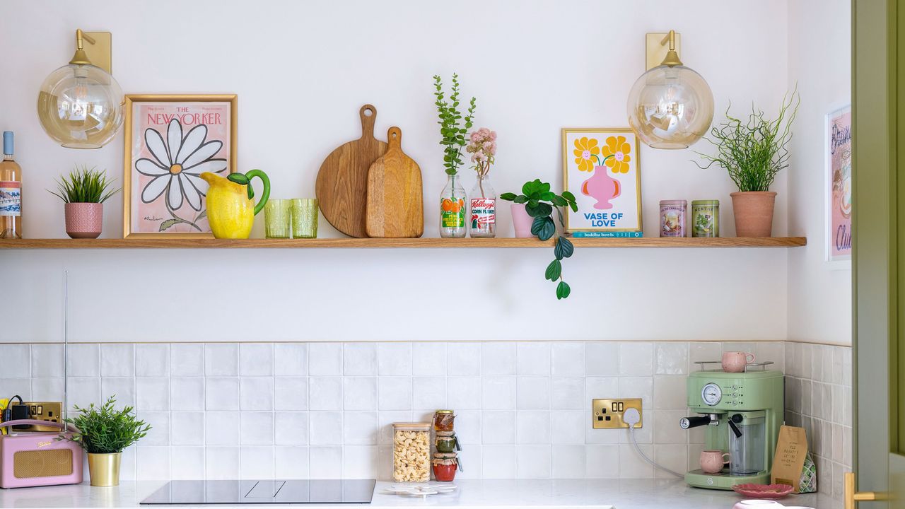 White painted and tiled kitchen with green painted kitchen cabinets and drawers with gold hardware