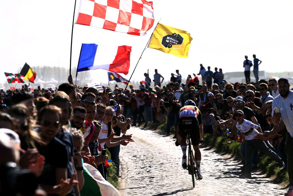 ROUBAIX FRANCE APRIL 17 Wout Van Aert of Belgium and Team Jumbo Visma competes passing through a cobblestones sector while fans cheer during the 119th ParisRoubaix 2022 Mens Elite a 2572km one day race from Compigne to Roubaix ParisRoubaix WorldTour on April 17 2022 in Roubaix France Photo by Etienne Garnier PoolGetty Images
