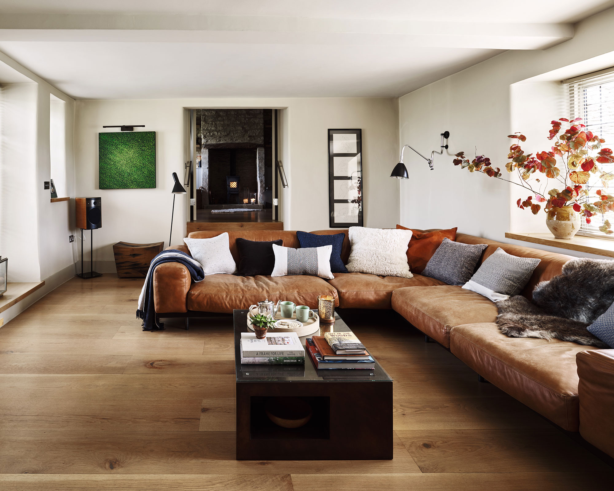 Brown living room with leather sofa and wood floor