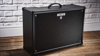 Best Guitar Amps Under $500: Boss Katana 100 on a wooden floor with white brick background 