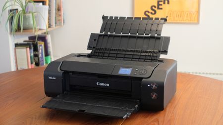 A photograph of the Canon imagePROGRAF PRO-310 printer with input and output trays unfolded