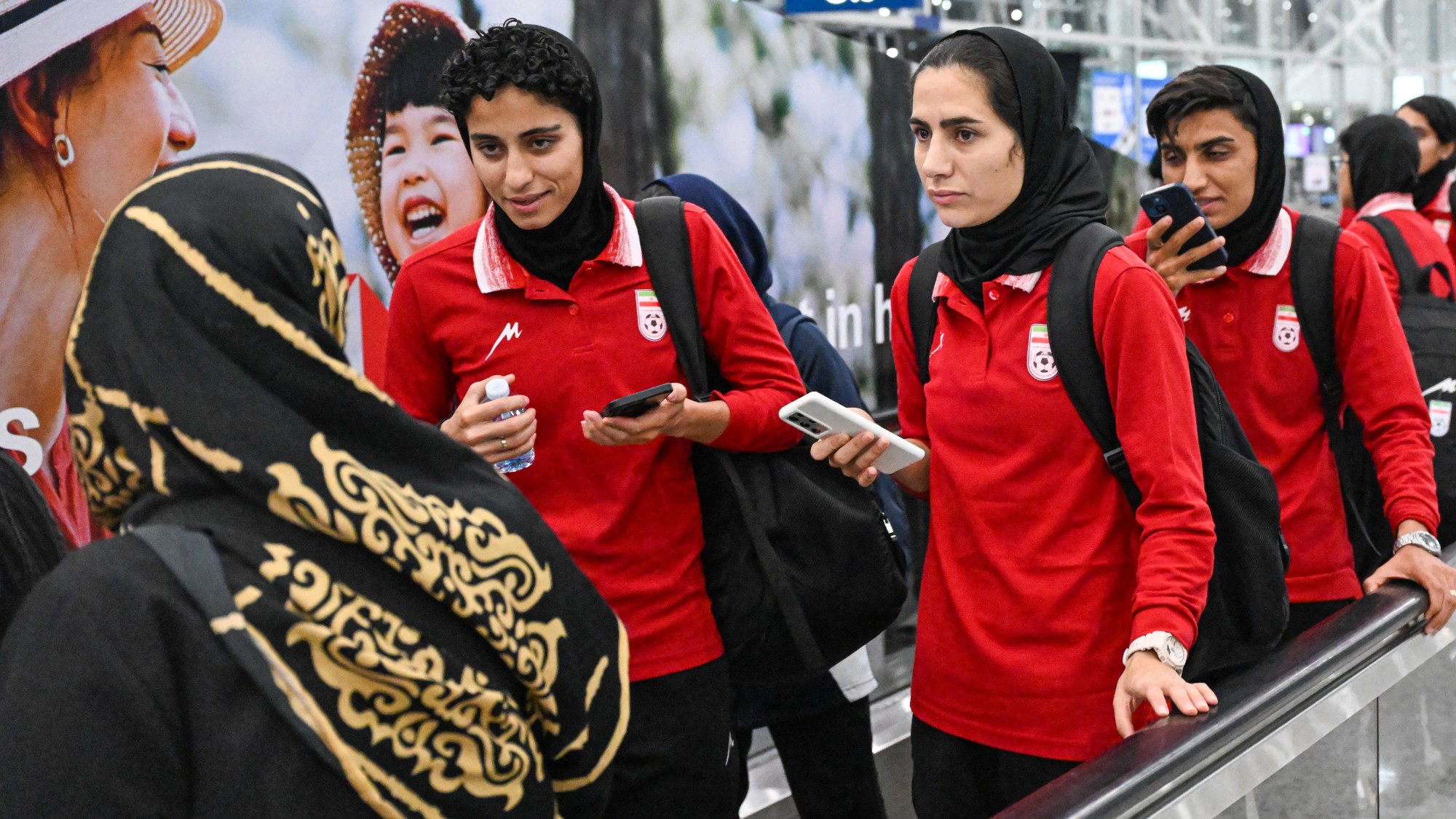 Members of Iran's women's football team arrive at the Kuala Lumpur International Airport on their way back from the AFC Women's Asian Cup