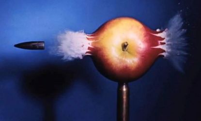 A photograph of a bullet ripping apart an apple: Light photons, which travel a million times faster than bullets, can now be captured on film thanks to new research.