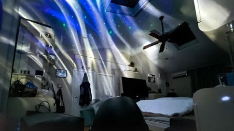 Govee Star Light Projector emits aurora pattern in bedroom