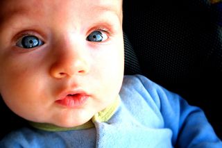 a young baby with blue eyes.