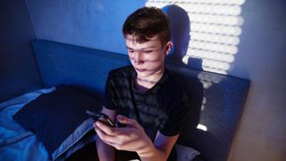 Boy being cyberbullied on his phone