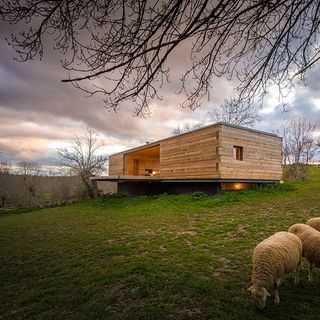 house exterior with wooden house and sheeps
