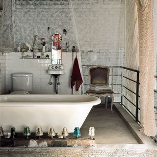 bathroom with white bathtub and chair