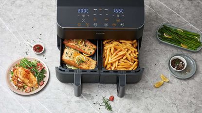 Cosori Dual Drawer Air Fryer bird's eye view with fries in one basket and salmon in another