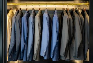 Elegant suits on coat hangers at a men's formal clothing store