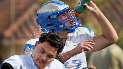 High school football players hydrate in Rancho Santa Margarita, California.
