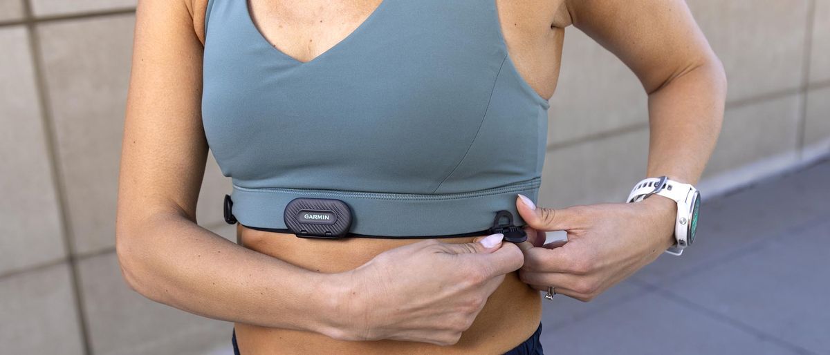 Woman adjusting the Garmin HRM-Fit