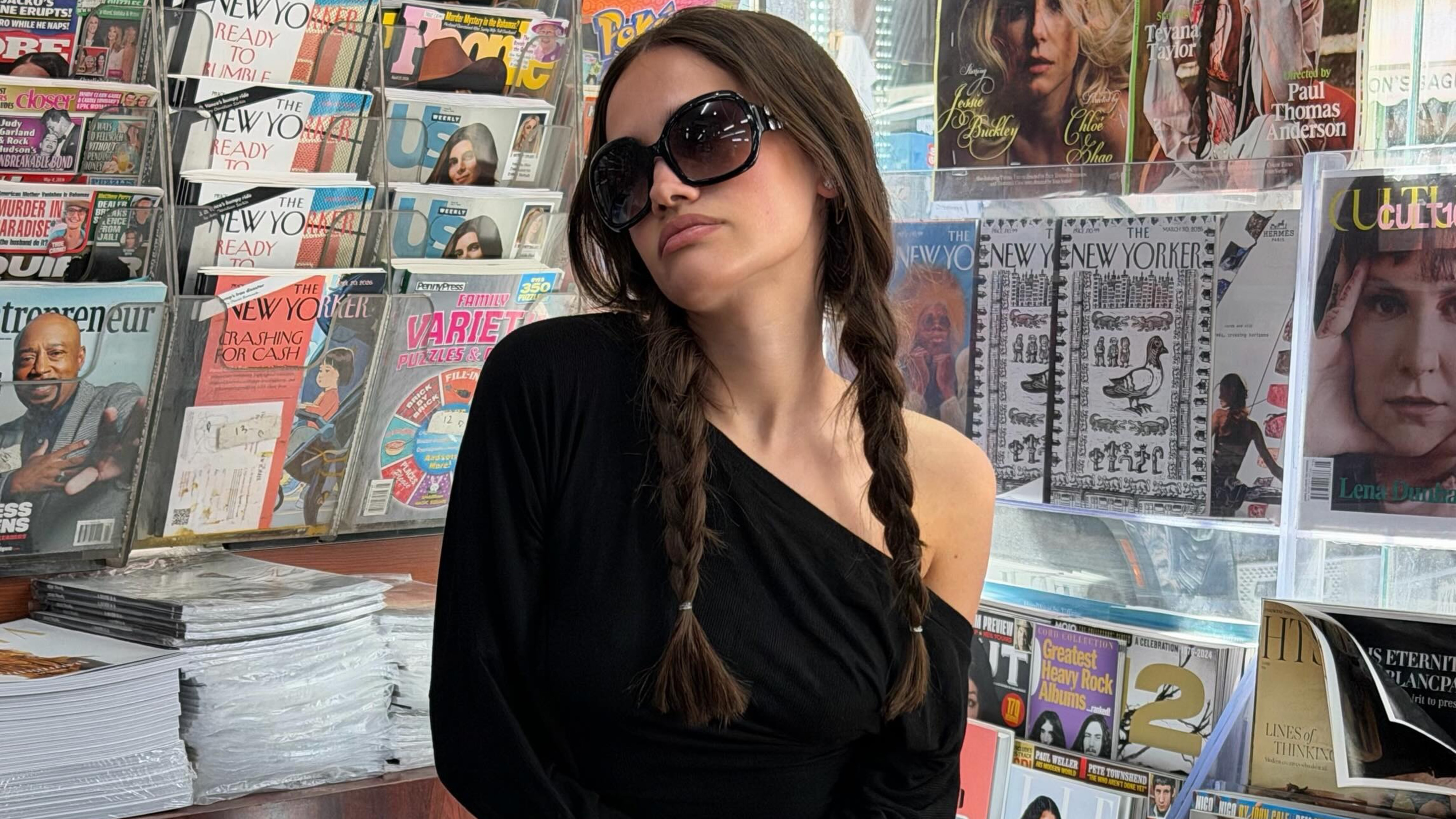 Julia wears a black top and oversize sunglasses.