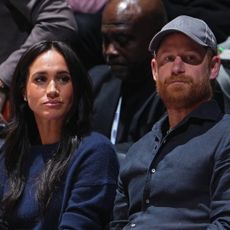 Meghan Markle and Prince Harry match in navy blue outfits while attending an NBA game