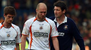  Luton Town manager Mick Harford consoles his dejected players after the Coca-Cola league two match between Luton Town and Chesterfield at Kenilworth Road on April 13, 2009 in Luton, England. Luton drew the match 0-0 and were subsequently relegated from the football league. (Photo by Clive Rose/Getty Images)