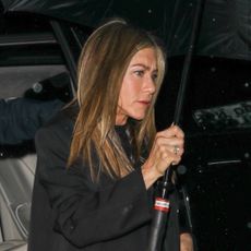 Jennifer Aniston wears cuffed blue jeans and white sneakers for date night with her new boyfriend