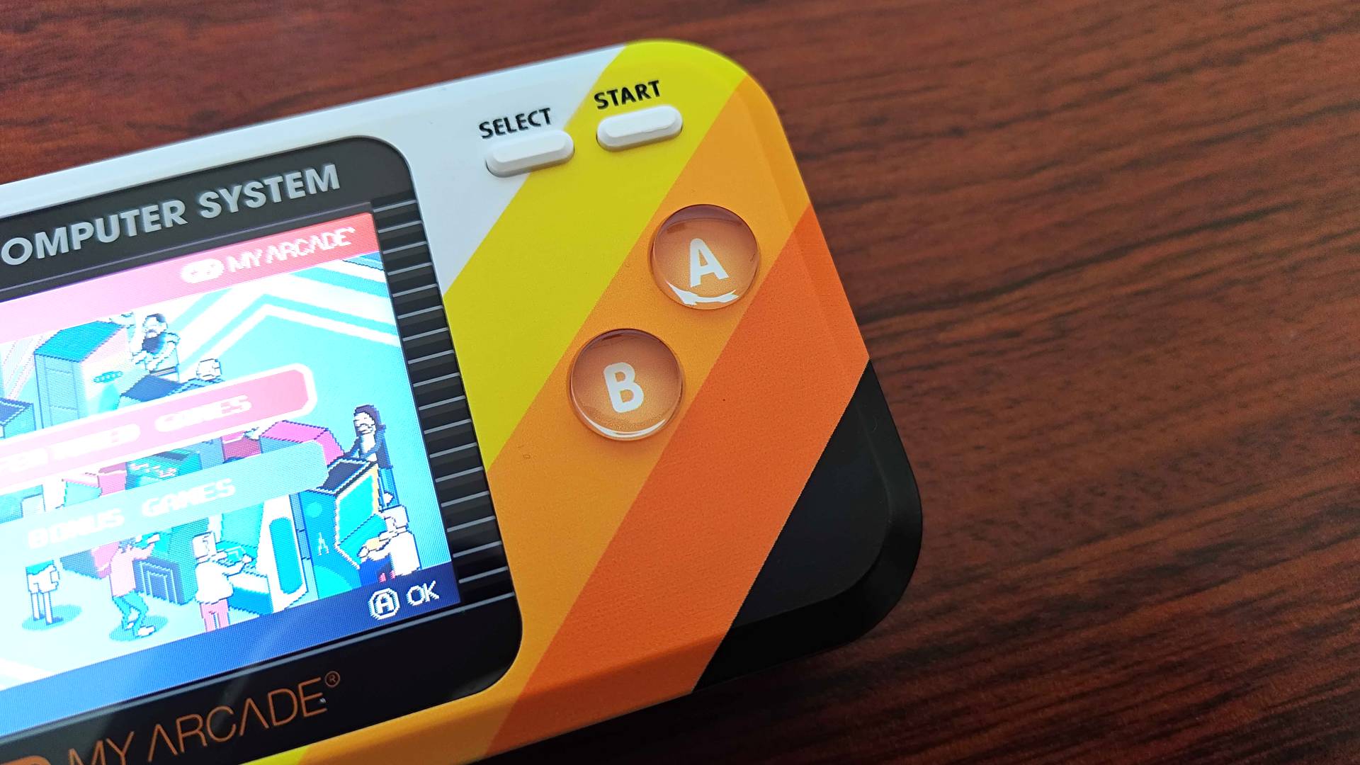 Close-up of Atari Pocket Player Pro handheld A and B buttons.