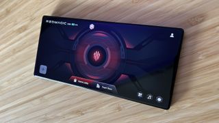 RedMagic 8S Pro showing game software in landscape mode on a wooden table