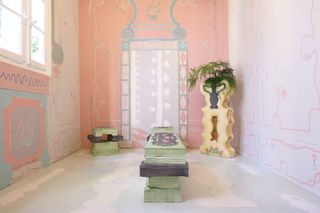 Pink room with irregular shaped furniture in light green